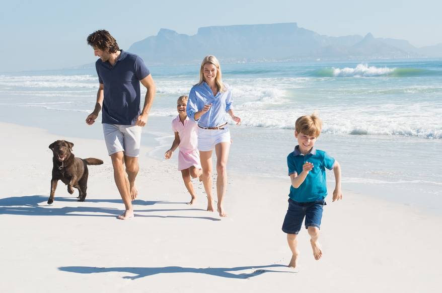 family-and-dog-running-on-beach
